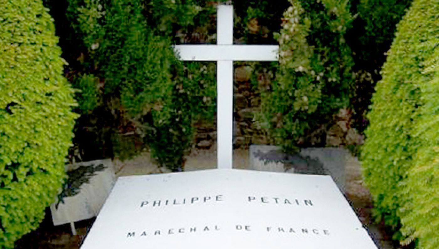 a cross of a grave with the name Philippe Petain