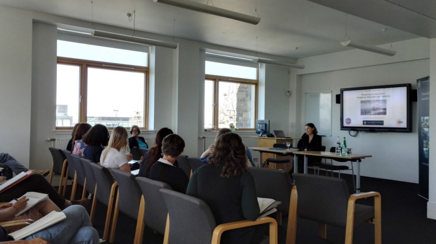 People sitting and listening to a presenter at a conference