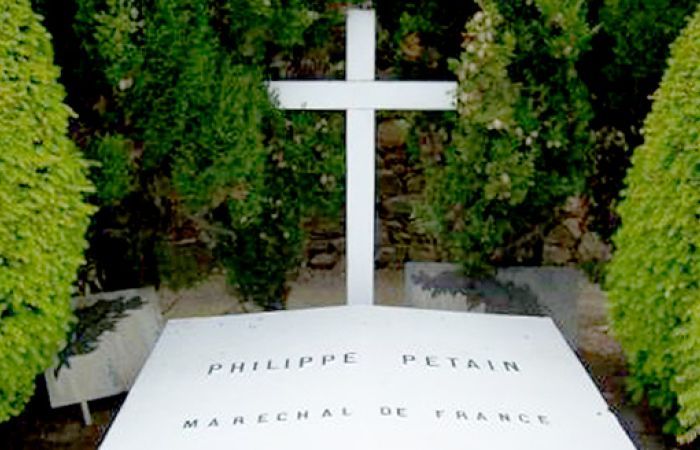 a cross of a grave with the name Philippe Petain
